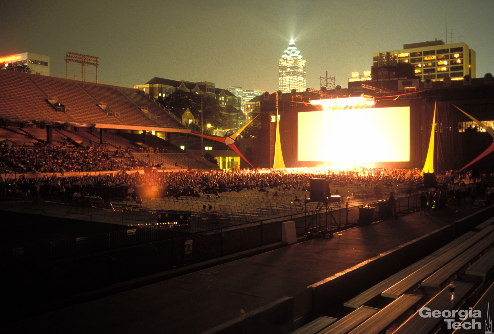 Picture of a screen in Bobby Dodd Stadium with a crowd watching