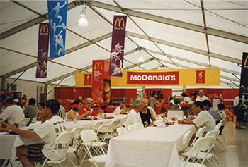 Picture of a McDonalds tent with people sitting down eating