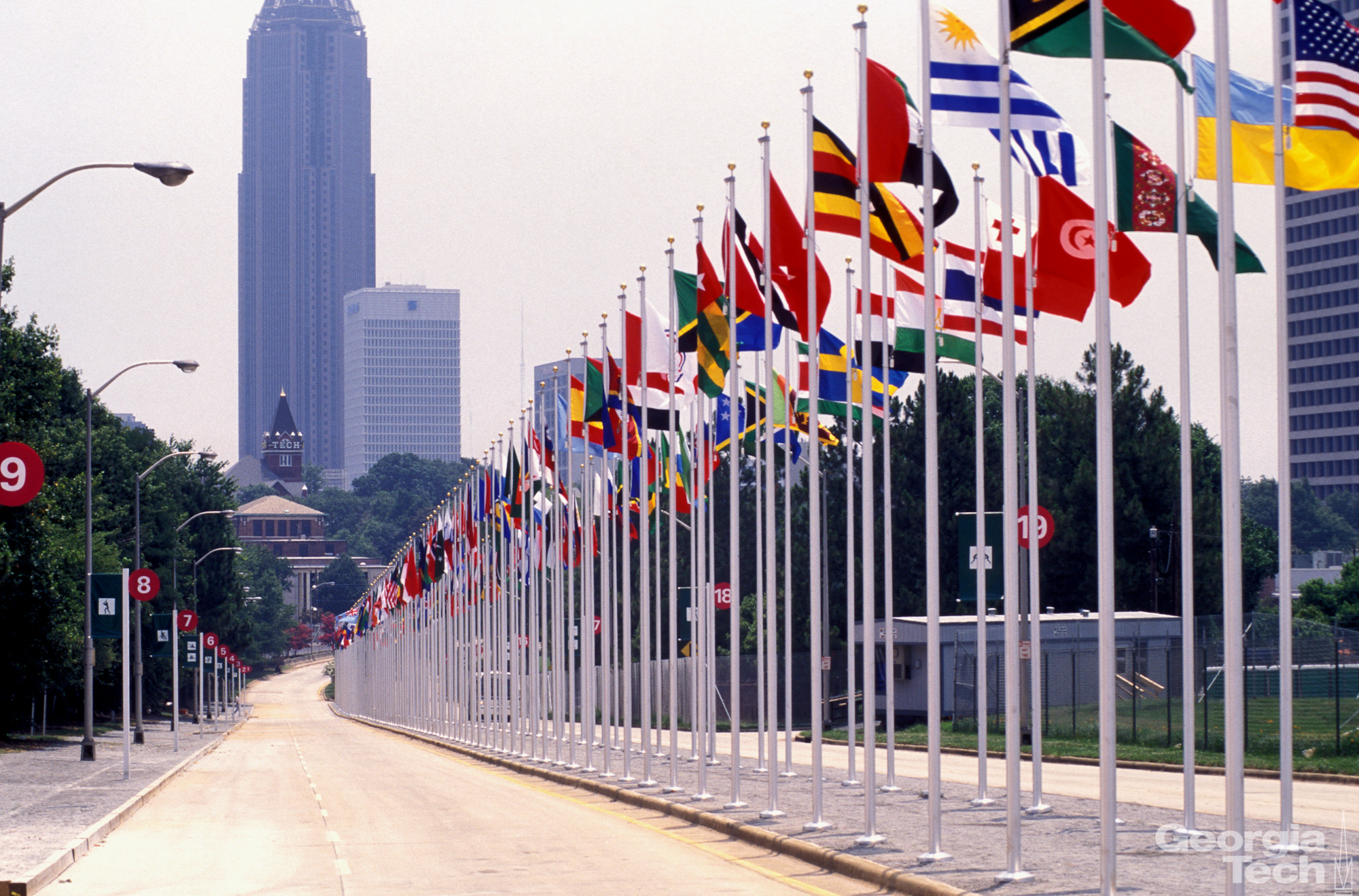 Walkway with National Flags, with Tech Tower and Atlanta Skyscrapers in The Background